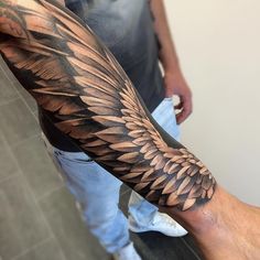 wings on forearm tattoo