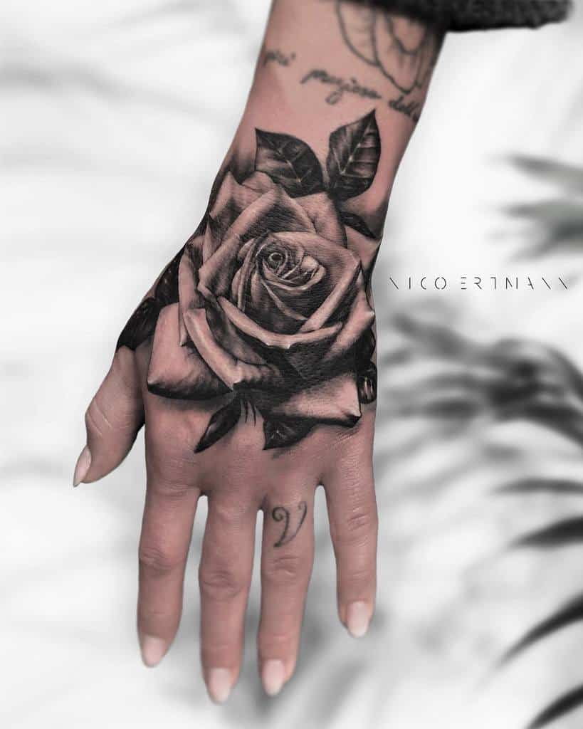 rose in hand tattoo