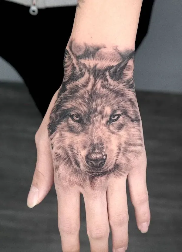 realistic wolf hand tattoo