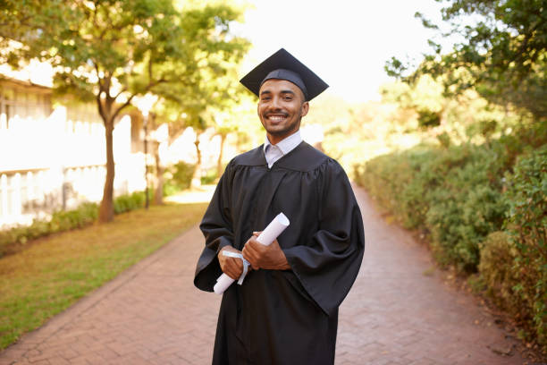 poses for graduation photos